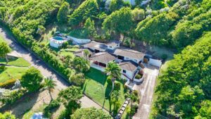 a house with a pool and trees